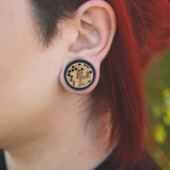 Areng Wood Double Flare Tunnel With Brass Honeycomb Inlay -Stretch It Body Jewellery areng wood double flare tunnel with brass honeycomb inlay model shot close up