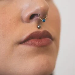 Blue Synth Opal & Brass Seamless Septum Ring -Stretch It Body Jewellery blue synth opal brass seamless septum ring model shot close up