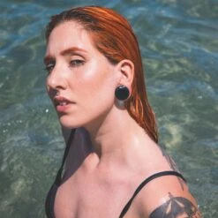 Faceted Teal Glass Double Flare Plug 9 Faceted Teal Glass Double Flare Plug -Stretch It Body Jewellery faceted teal glass double flare plug model shot kate two