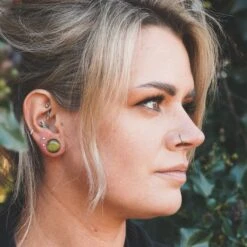 Peridot Cat's Eye Glass Single Flare Convex Plug -Stretch It Body Jewellery peridot single flare cats eye plug model shot close up